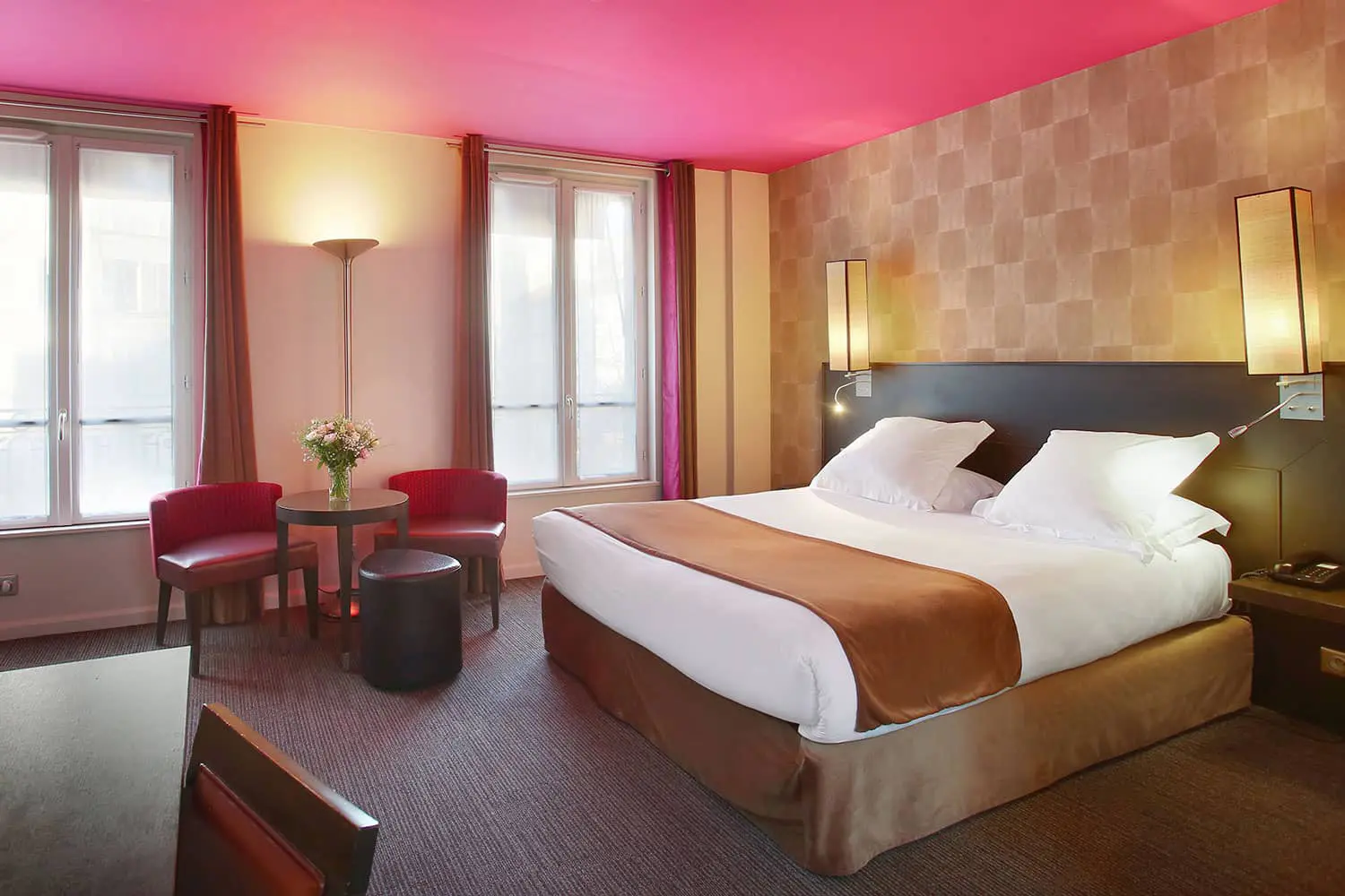 Chambre double avec lit king-size, plafond fuchsia, papier peint doré, fauteuils rouges et doubles fenêtres, hôtel Aéro Paris 16e